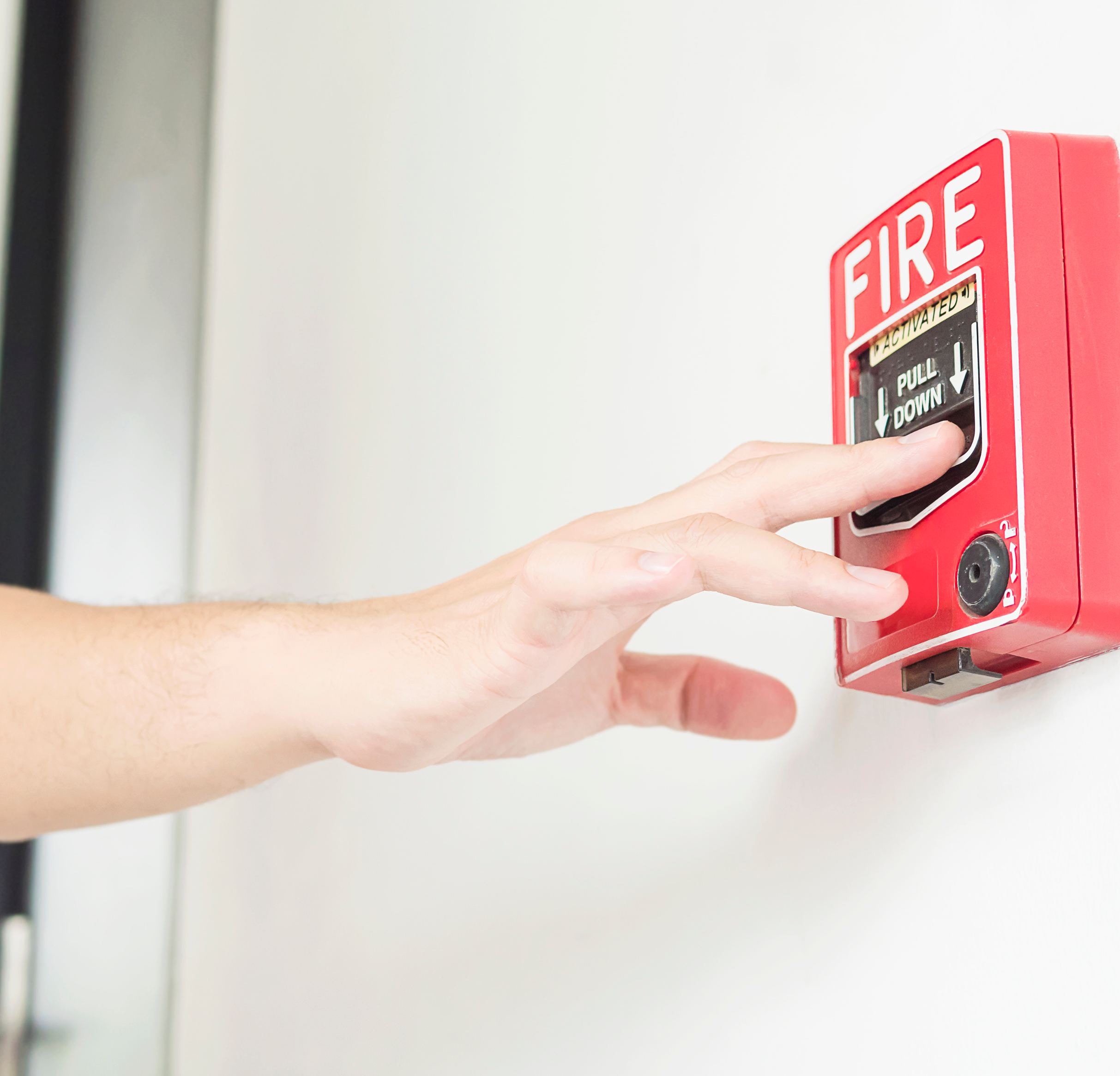 man-is-reaching-his-hand-to-push-fire-alarm-hand-station